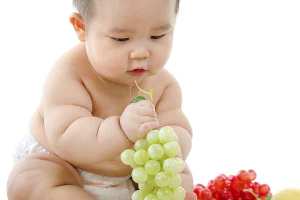 Baby eating grapes
