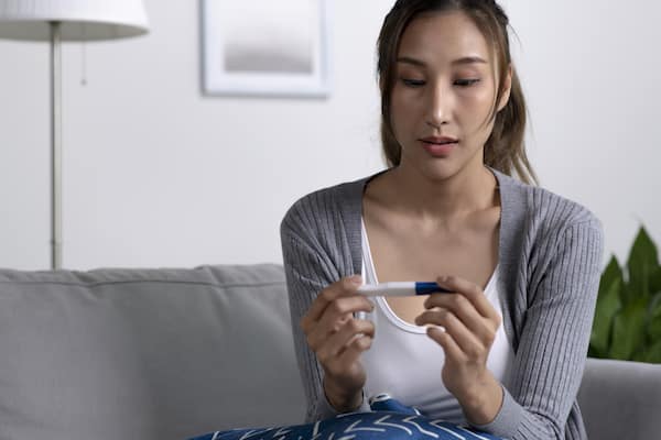 Woman holding pregnancy test kit