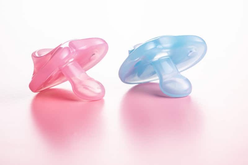 Pink and blue silicone pacifiers