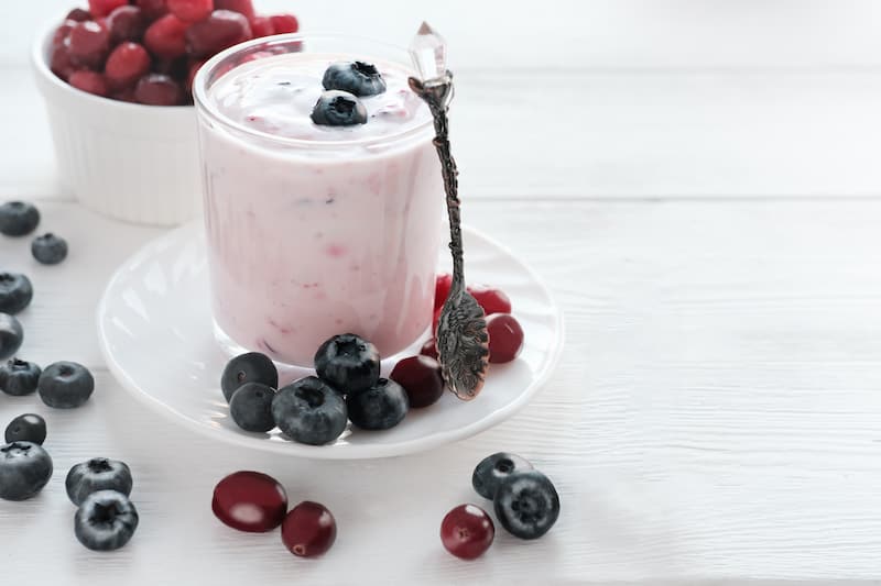 Yogurt with berries in a glass.