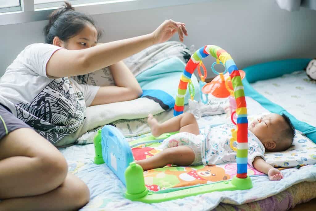 Domestic helper playing with an infant