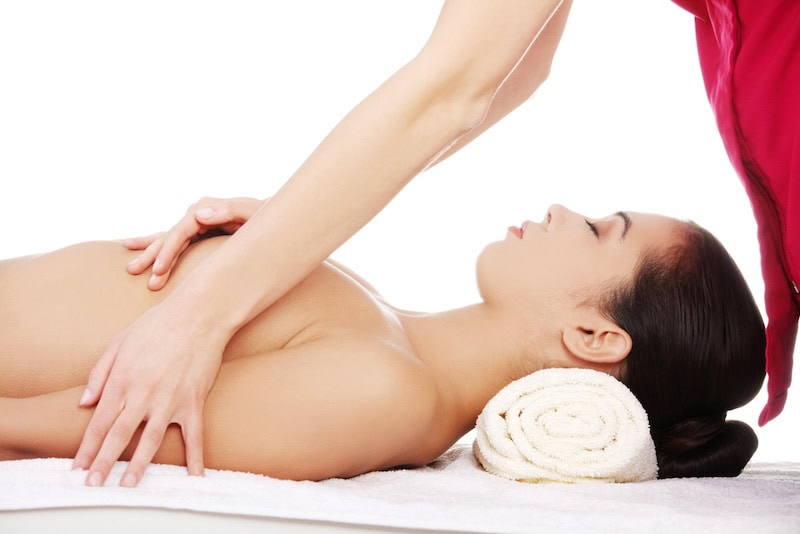 A woman receiving a breast massage